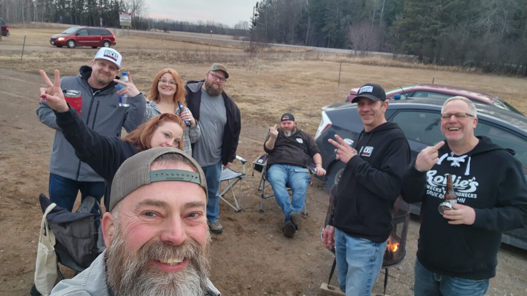 eight poeple hanging out in a parking lot